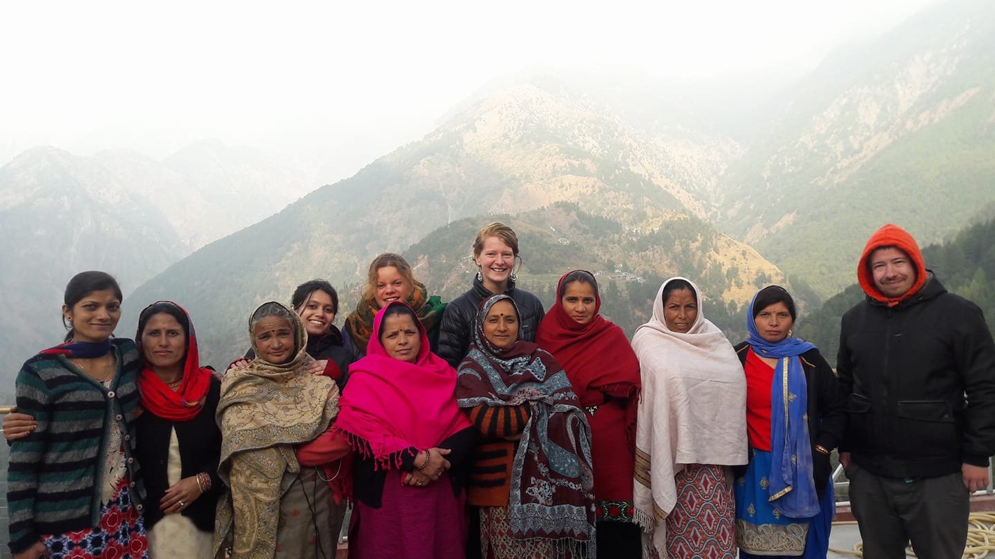 A CIEEL cohort standing with women's collective leaders against the Dhauladhar range, western Himalayan foothills